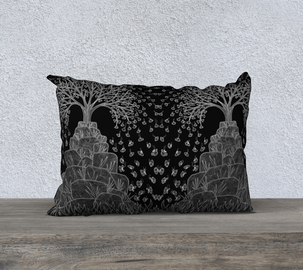 Rectangular black and white art-printed pillow with image of two trees on rocks. 
