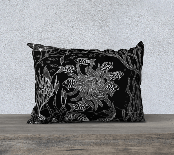 Rectangular black and white art-printed pillow, with images of plants and fish.