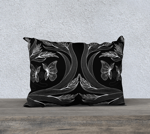Rectangular black and white art-printed pillow with design of butterflies and plants. 